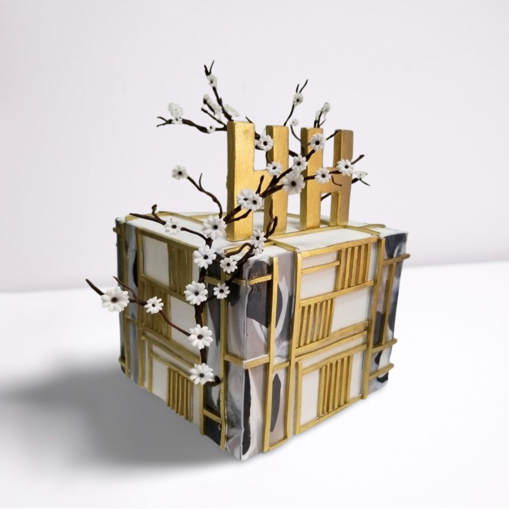 Gold and White Cube-Shaped Cake with Custom Name and Flowers
